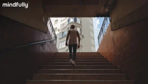 Person walking up stairs toward daylight, representing overcoming negative thinking