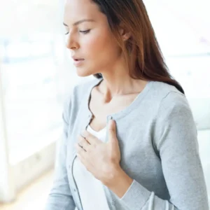 Person practicing deep breathing and mindfulness to calm anxiety quickly.