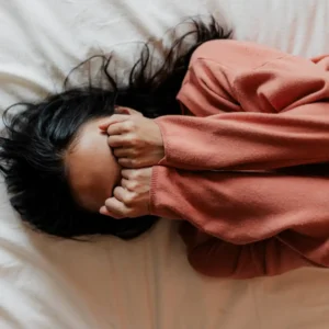 Person practicing deep breathing to manage anxiety effectively.