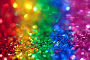 Colorful rainbow glitter background with sparkling accents