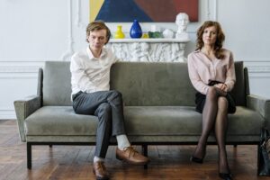 A couple engages in family counseling while seated on a couch