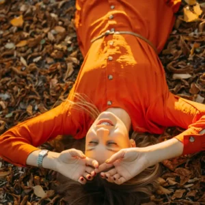 Person enjoying fall self-care activities like cozy reading and warm beverages.