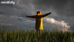 A person embracing a stormy sky with open arms, representing the journey of overcoming catastrophizing and expecting the worst.
