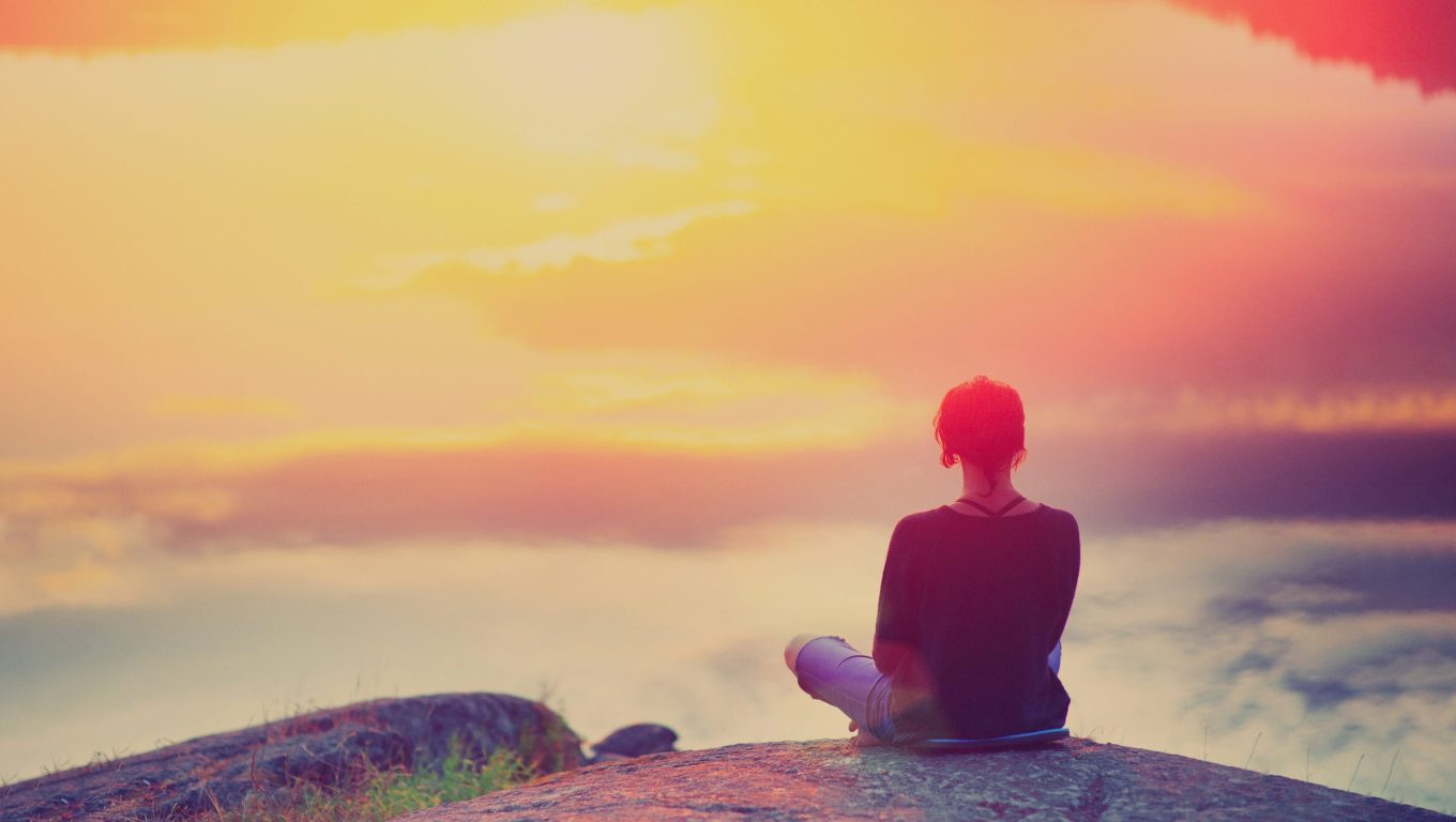 A person sitting on a rock