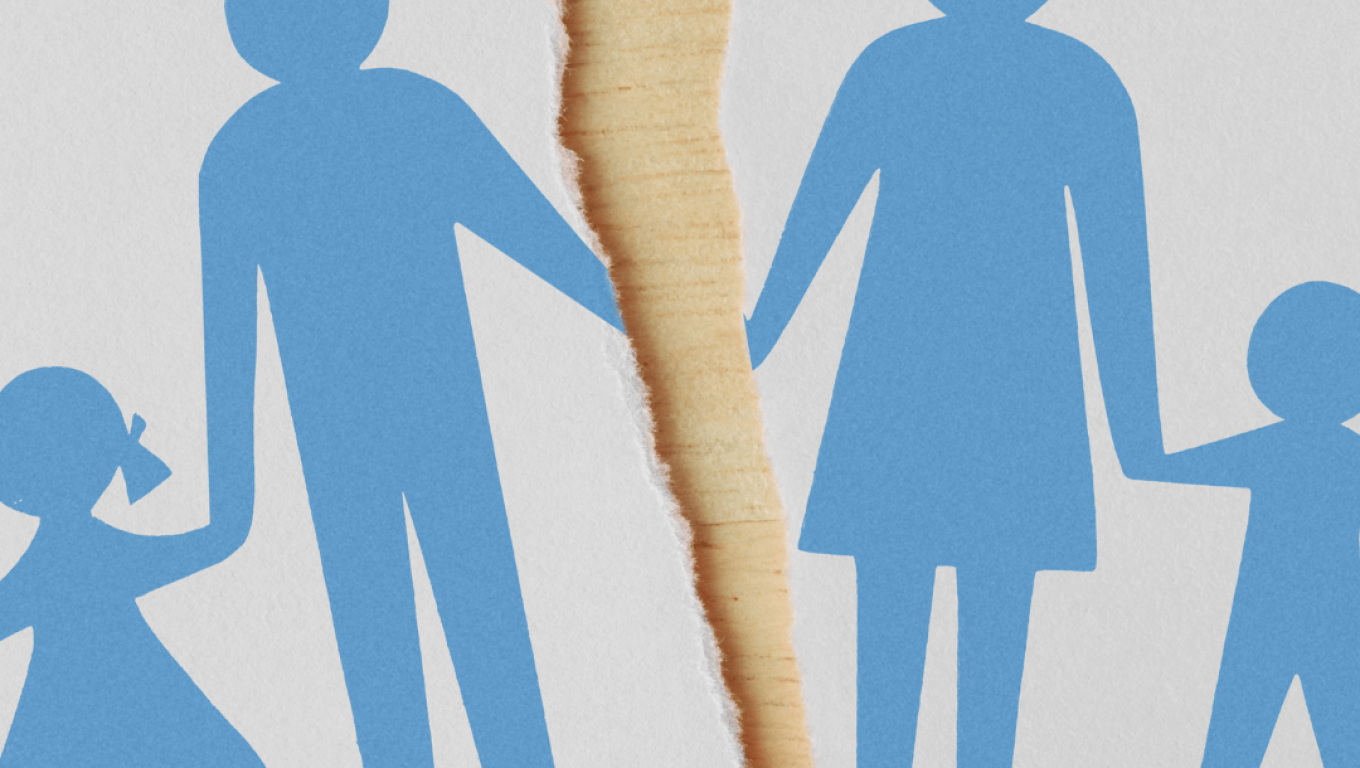A family holds hands while displaying a paper with a silhouette of themselves together.