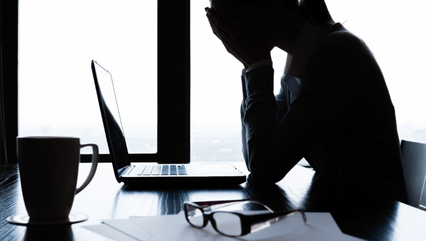 A stressed woman sitting at a desk
