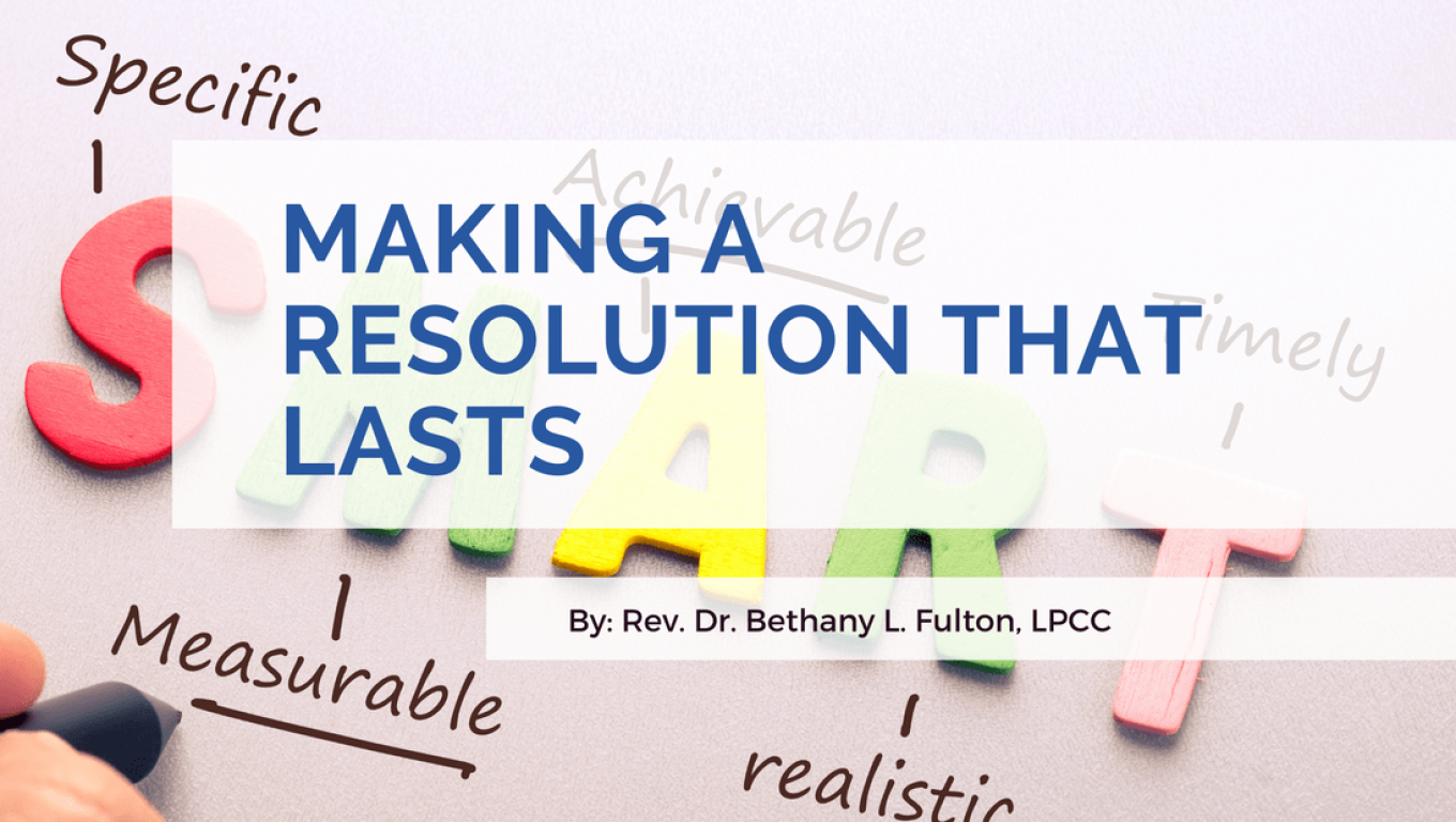 A person writing down their long-term resolutions in a notebook