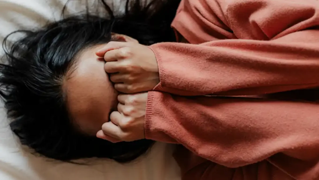 Person practicing deep breathing to manage anxiety effectively.
