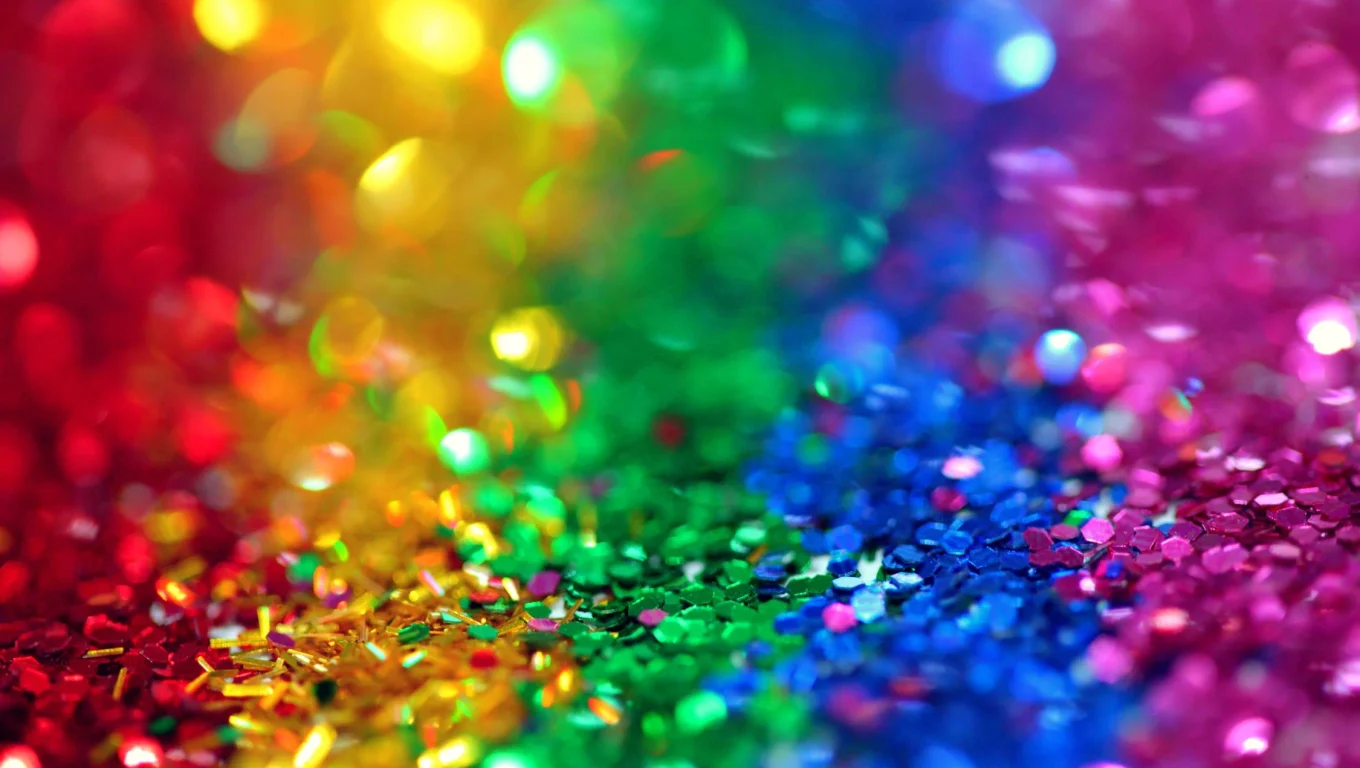 Colorful rainbow glitter background with sparkling accents
