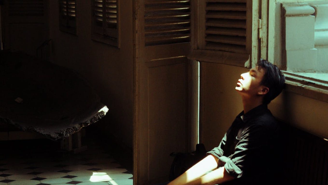A man on a bench in a room