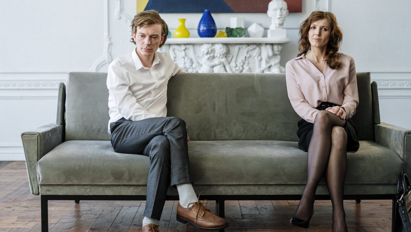 A couple engages in family counseling while seated on a couch