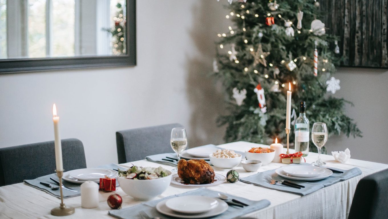 A festive Christmas dinner table set with decorations