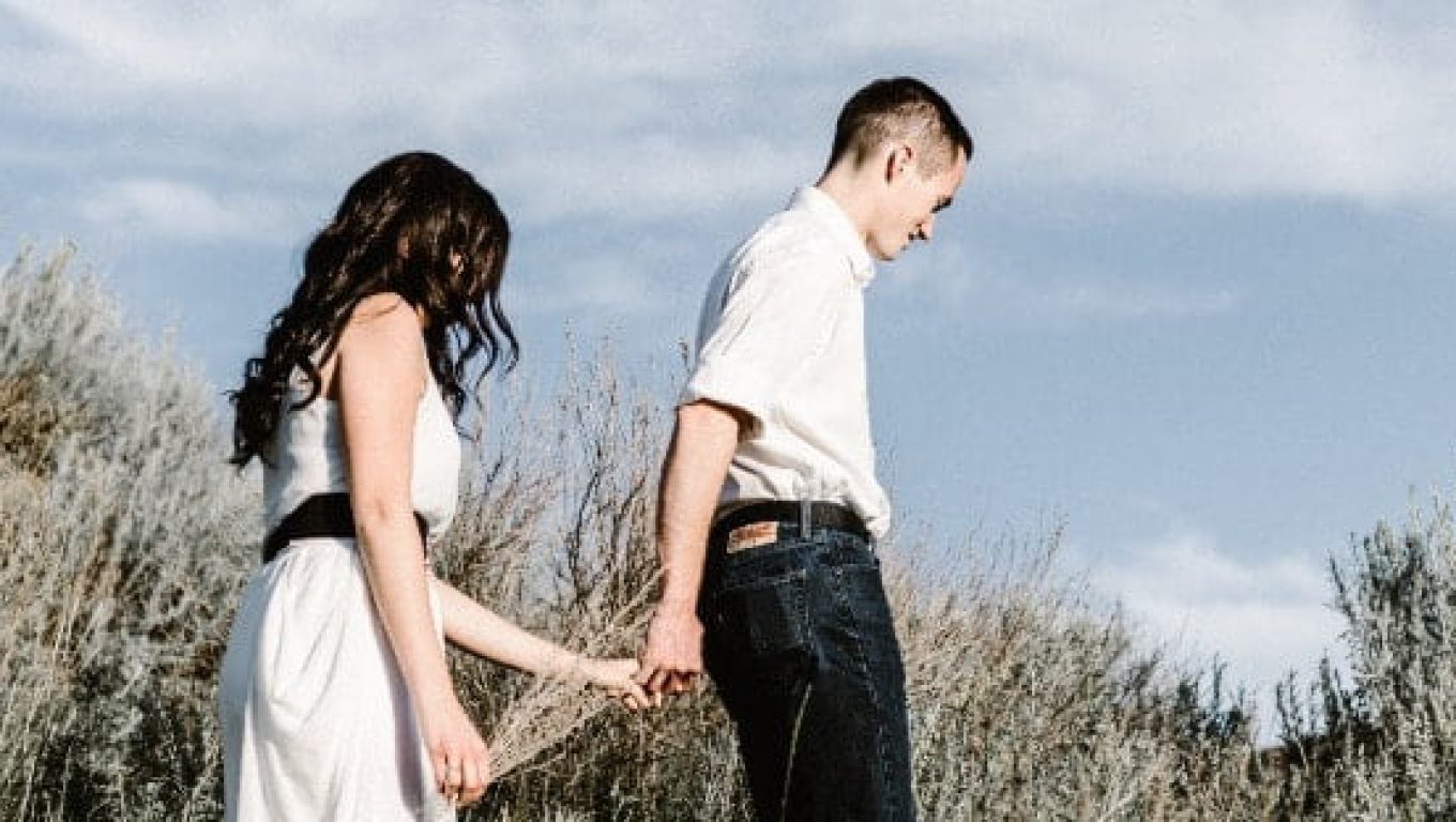 A man and woman holding hands