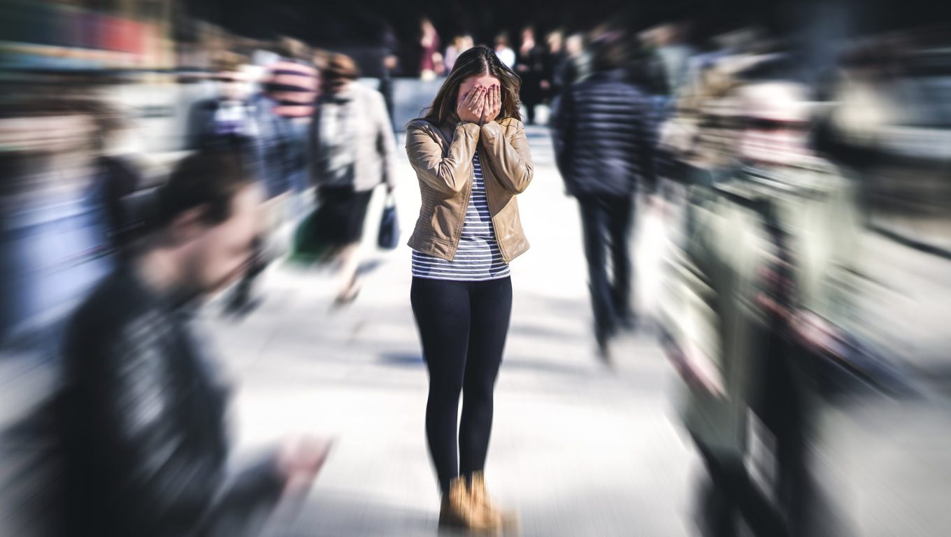 A woman walks through a crowded area