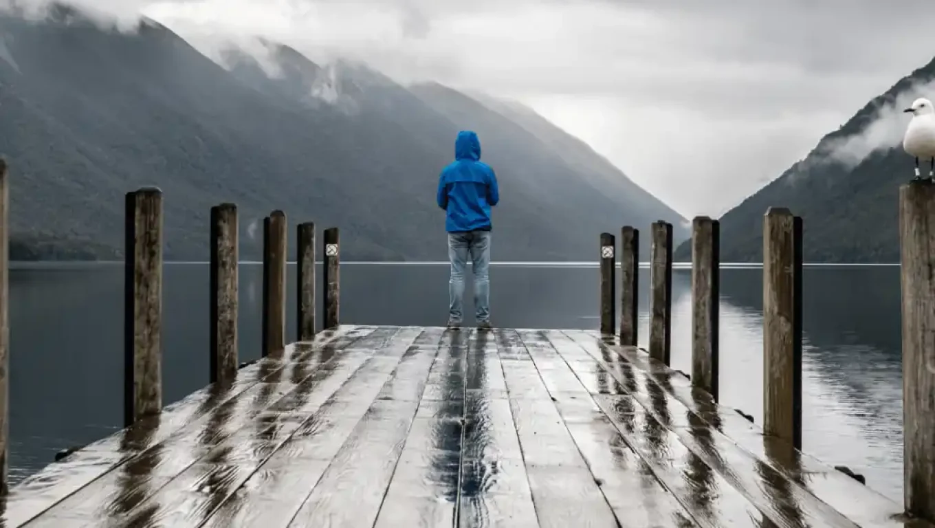 A person stands on a dock